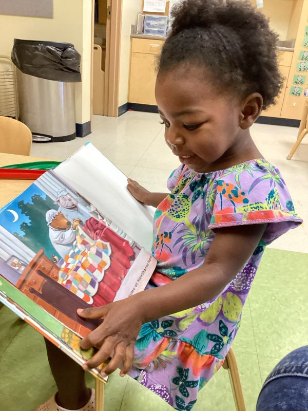 Olivia Reading a Book at School